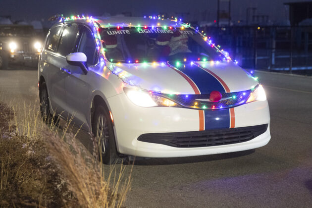 One of many vehicles, dubbed "White Lightning Kitt," waits for the Santa Parade to begin.